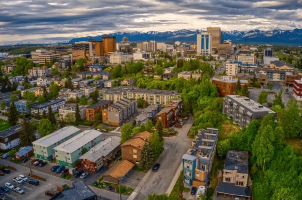 Anchorage skyline and Chugach Mountains viewed from above on a transfer with sightseeing